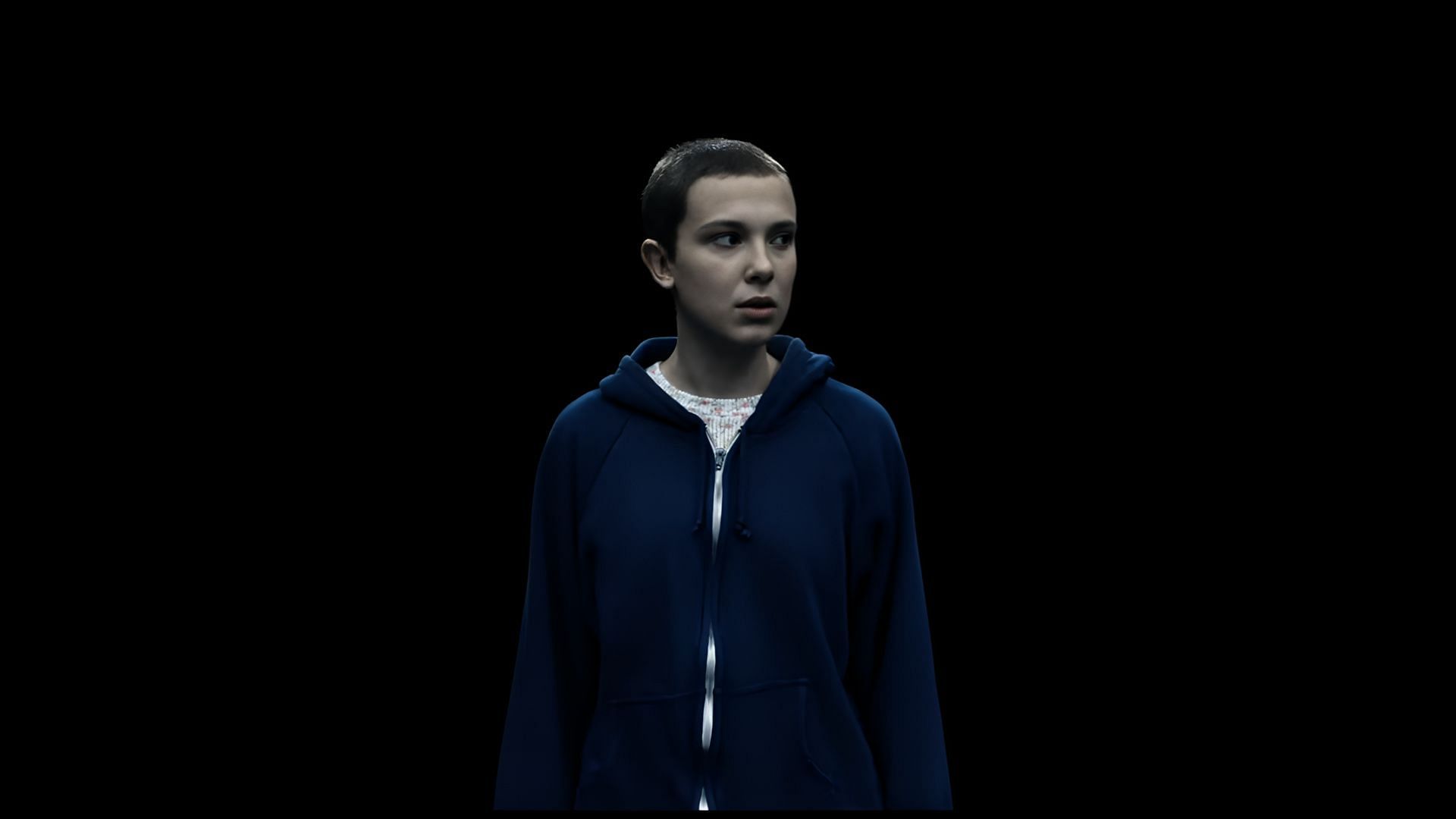 Stranger Things' Eleven stands alone in the void, foreshadowing her descent into the shadows after being trapped in the Upside Down. (Image via Netflix)